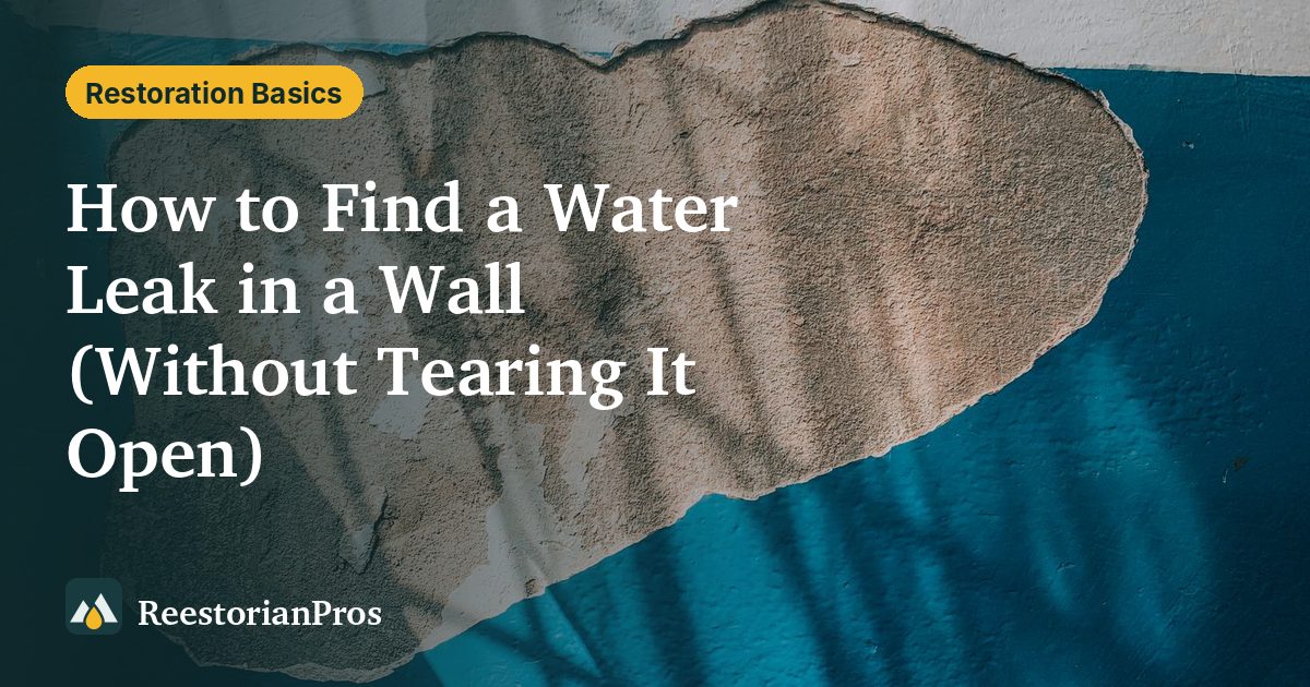 Patch of missing paint and exposed plaster on a teal wall